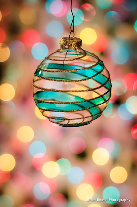 Christmas bauble with colourful fuzzy background 