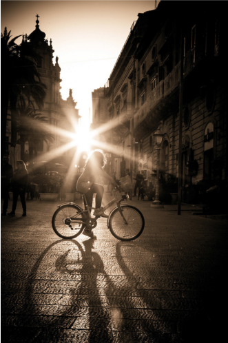 Cyclist in Ragusa Sicily backlit